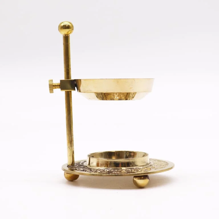 Adjustable brass resin incense warmer with a polished brass body and a resin incense holder