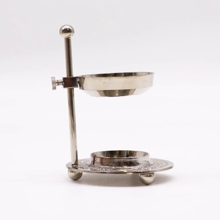 Plated brass incense warmer with adjustable resin holder.