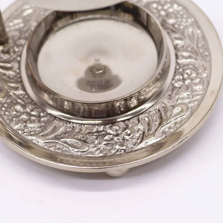 Adjustable plated brass incense warmer resin on a neutral background
