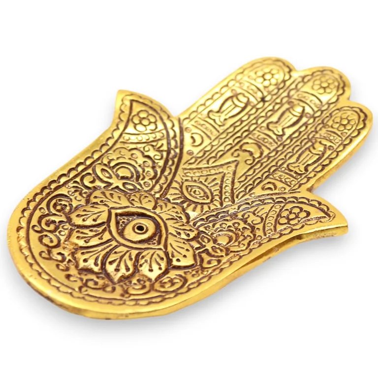 Small incense holder in gold aluminium with a Hamsa design.