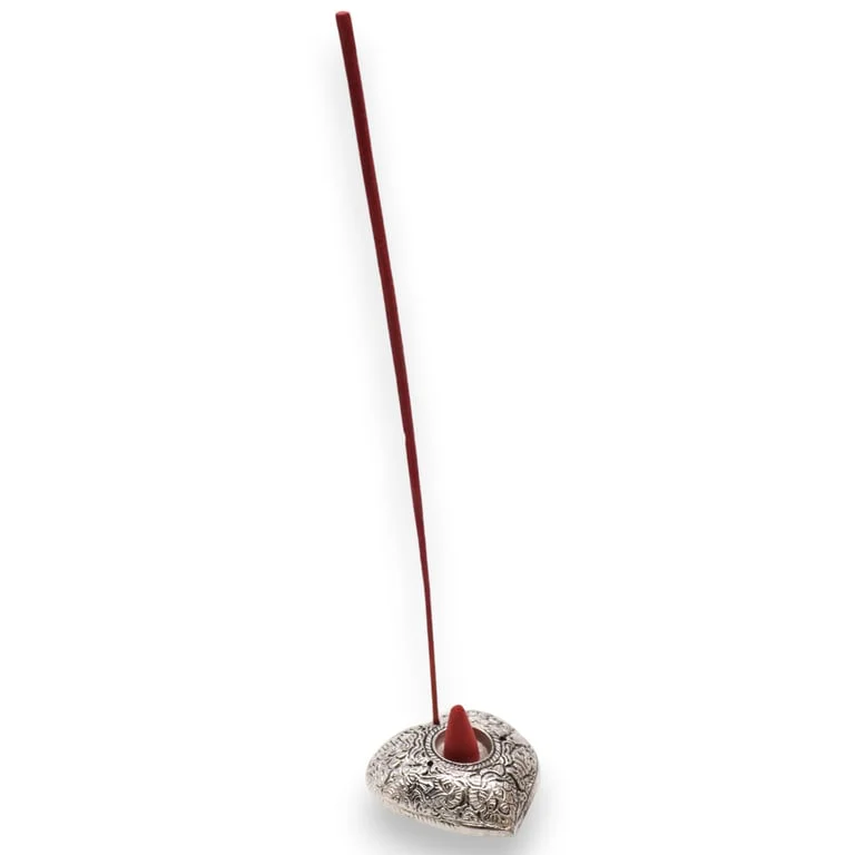 heart-shaped small incense holder on a flat surface
