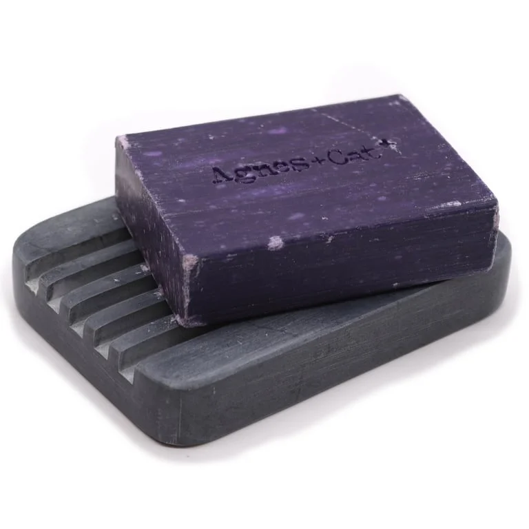 Grey soapstone soap dish with heavy ridges, measuring 12x8.5cm, rectangular shape for bathroom use