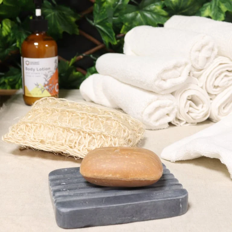 Grey soapstone bathroom soap dish with heavy ridges, measuring 12x8.5cm, shown from a side angle