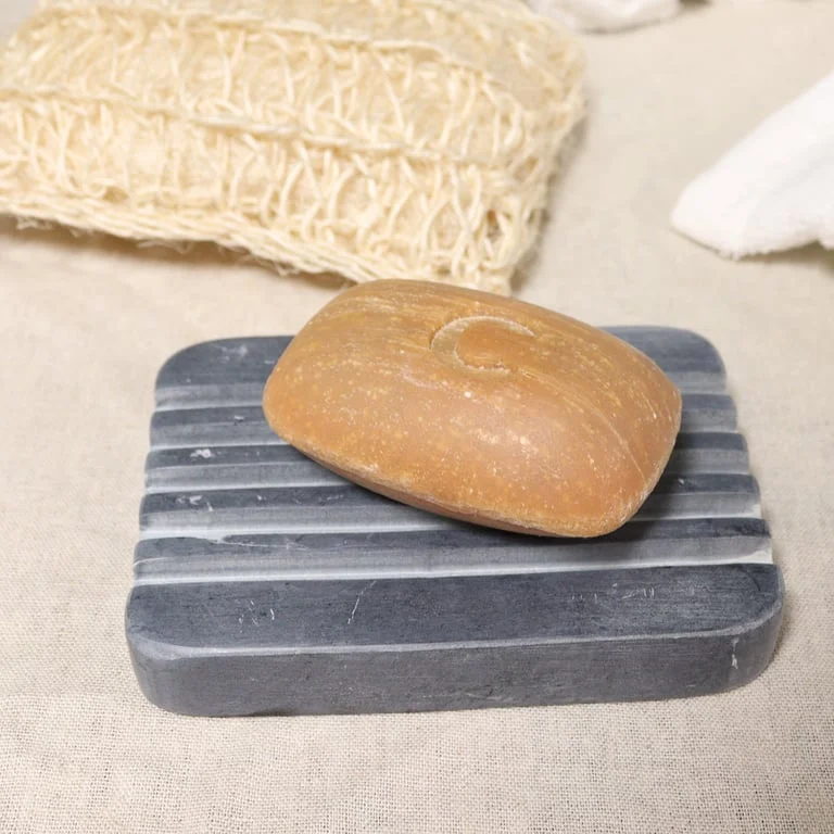 Grey soapstone stone soap holder with heavy ridges, measuring 12x8.5cm, designed for holding soap bars