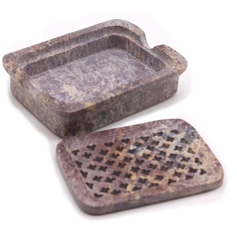 Classic square soap dish made from soapstone, 11x8 cm, with a raised rim for soap drainage.