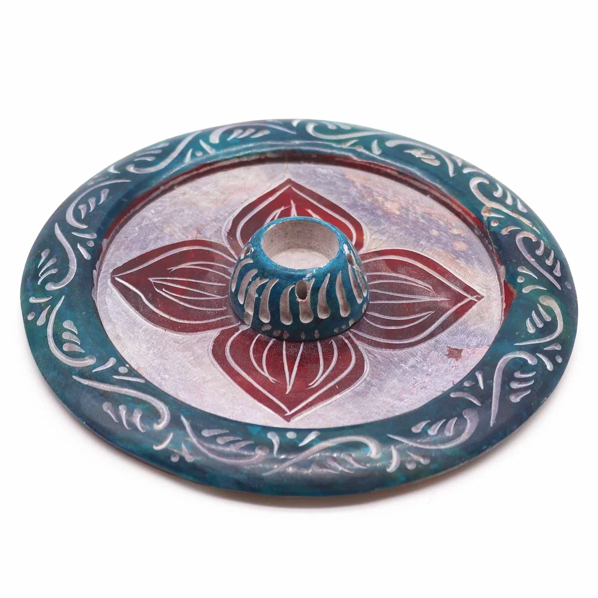 Soapstone incense holder shaped like a four-petal disc with a cone incense placed in the center slot