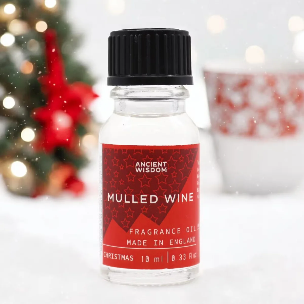 Small 10ml bottle of Mulled Wine aromatherapy fragrance oil with festive label on white background