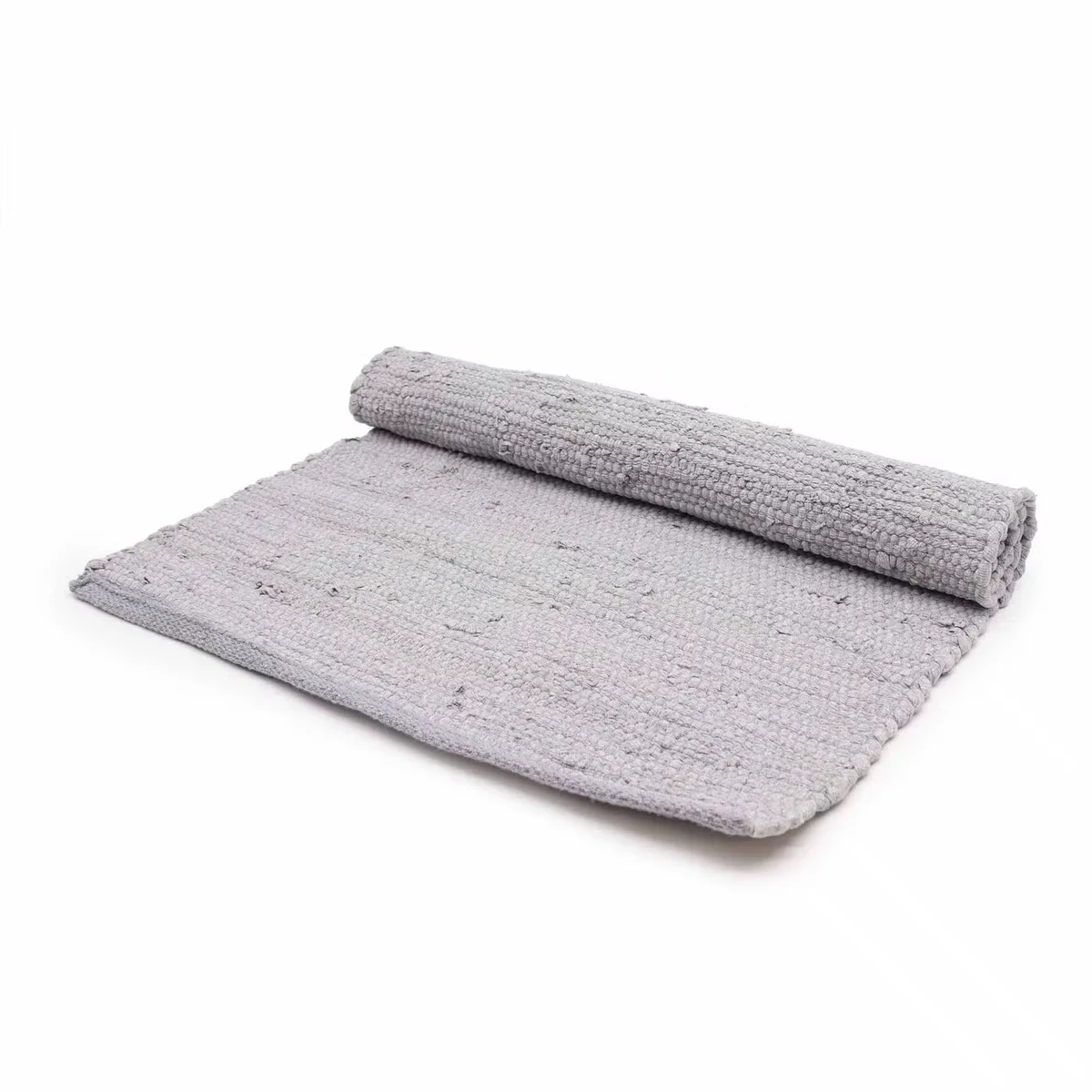 Grey handloom cotton throw laid on a wooden floor, showcasing fine woven texture.