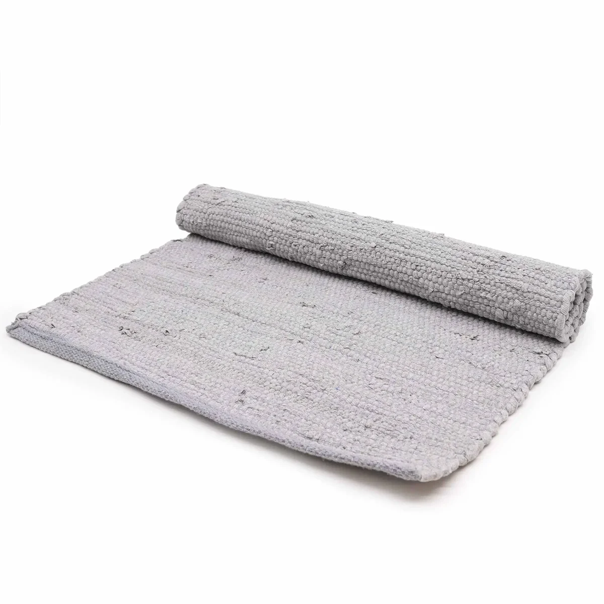Grey handloom cotton rug laid out in a living room, showcasing large Indian handloom rug texture