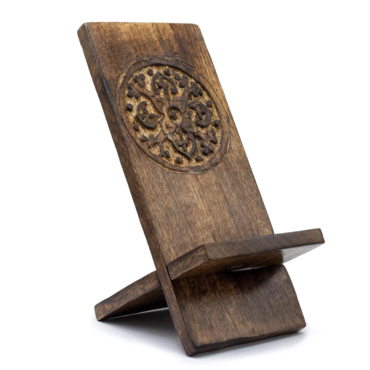 Wooden phone stand with intricate mandala carving designed to hold a smartphone upright on a flat surface