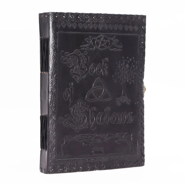 Large black notebook open to a page, black cover, compact 25x18x3cm book.