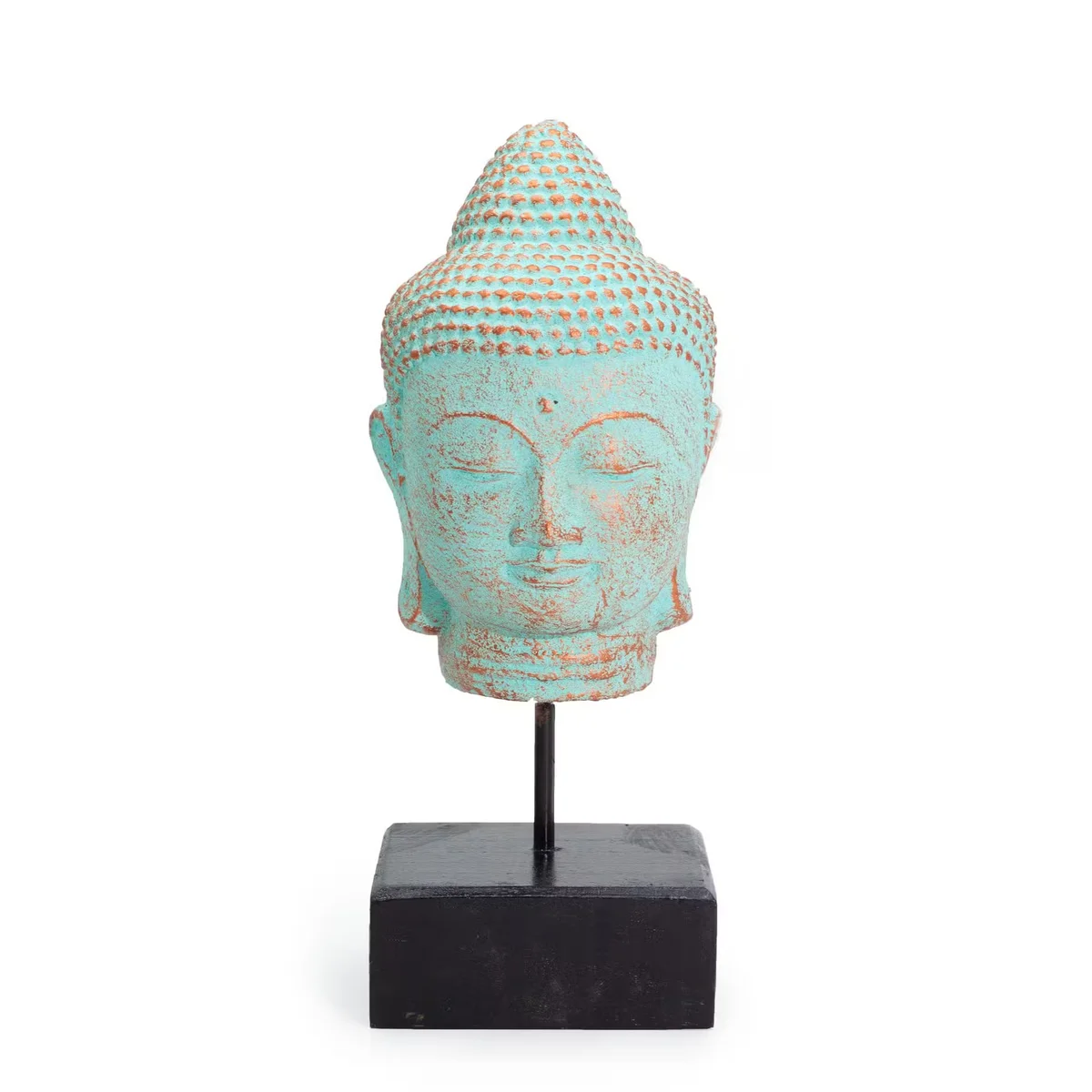 Green copper decorative Buddha figurine head on stand with serene expression, representing stillness and calm decor piece