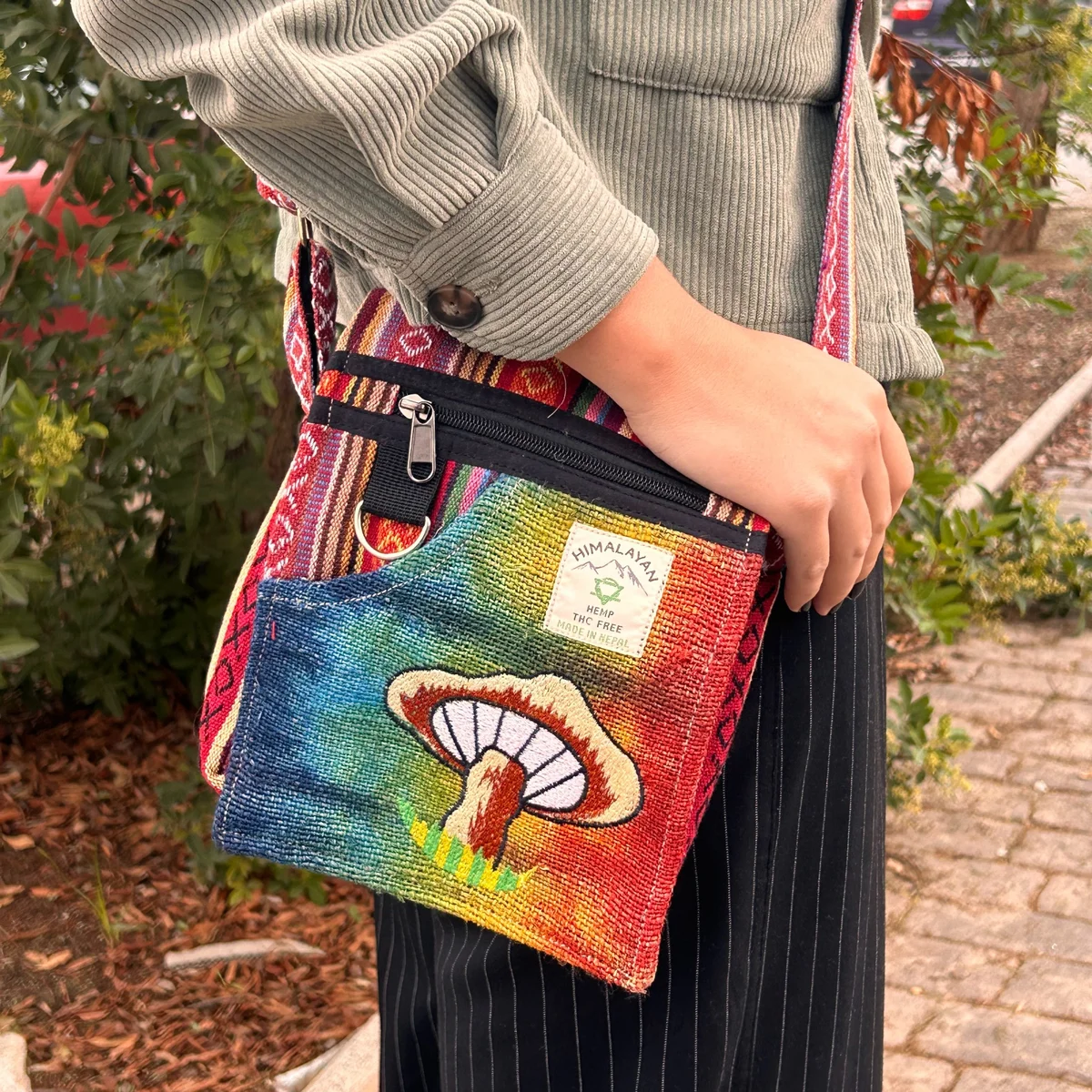 Orange mushroom handbag made of hemp with detailed embroidery, showcasing vibrant orange mushrooms on natural fabric background