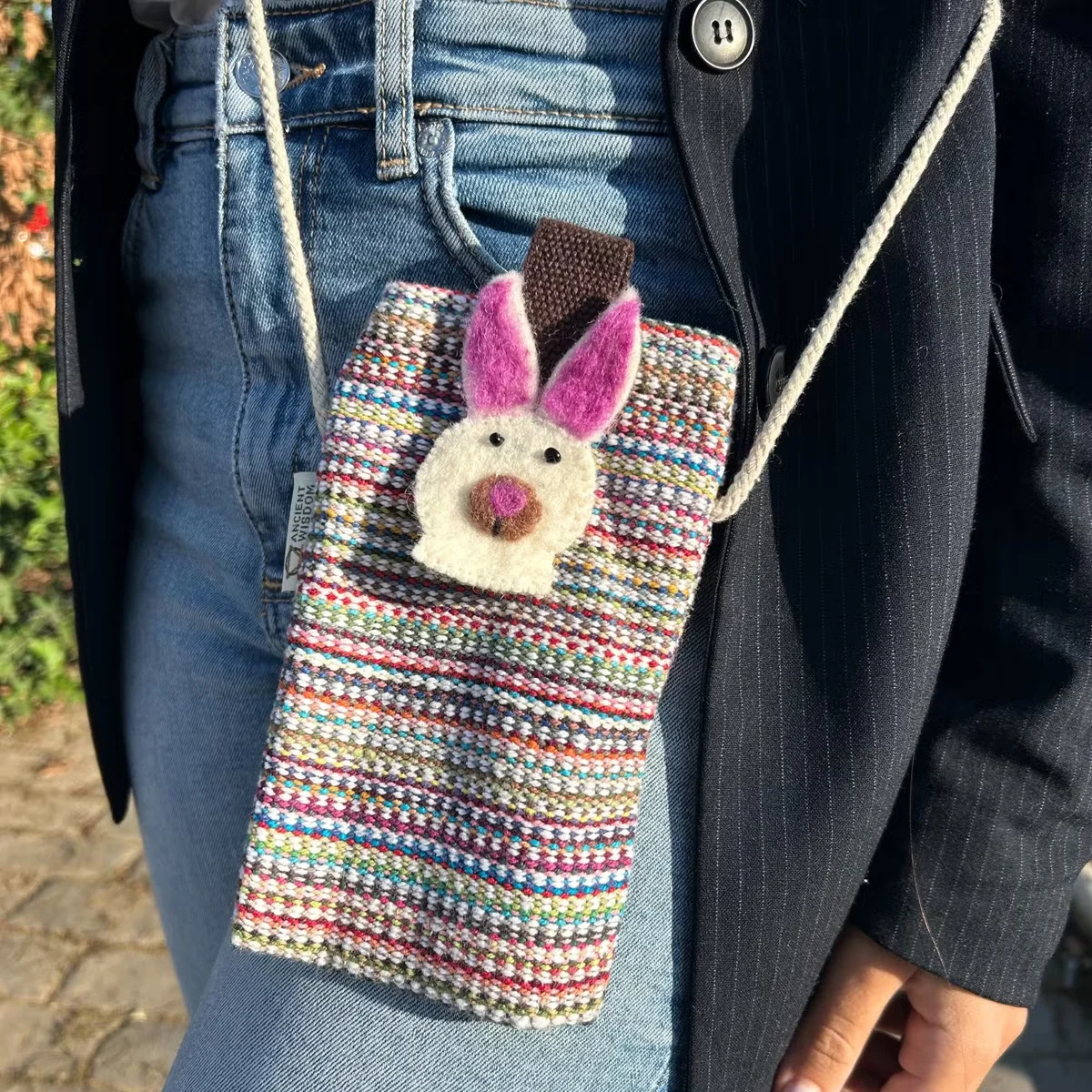 Small phone bag with pink stripes and bunny decor, designed as a phone holder bag