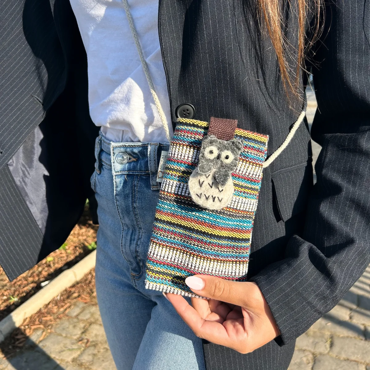 Multi white phone pouch with striped pattern and owl decor, designed as a phone holder bag