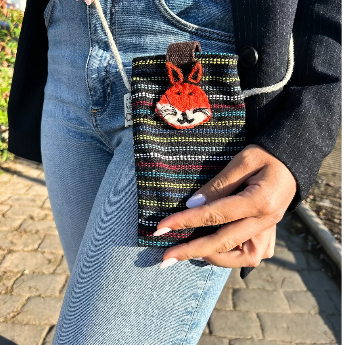Black phone bag with multi-colour fox decor design, compact and stylish holder for smartphones