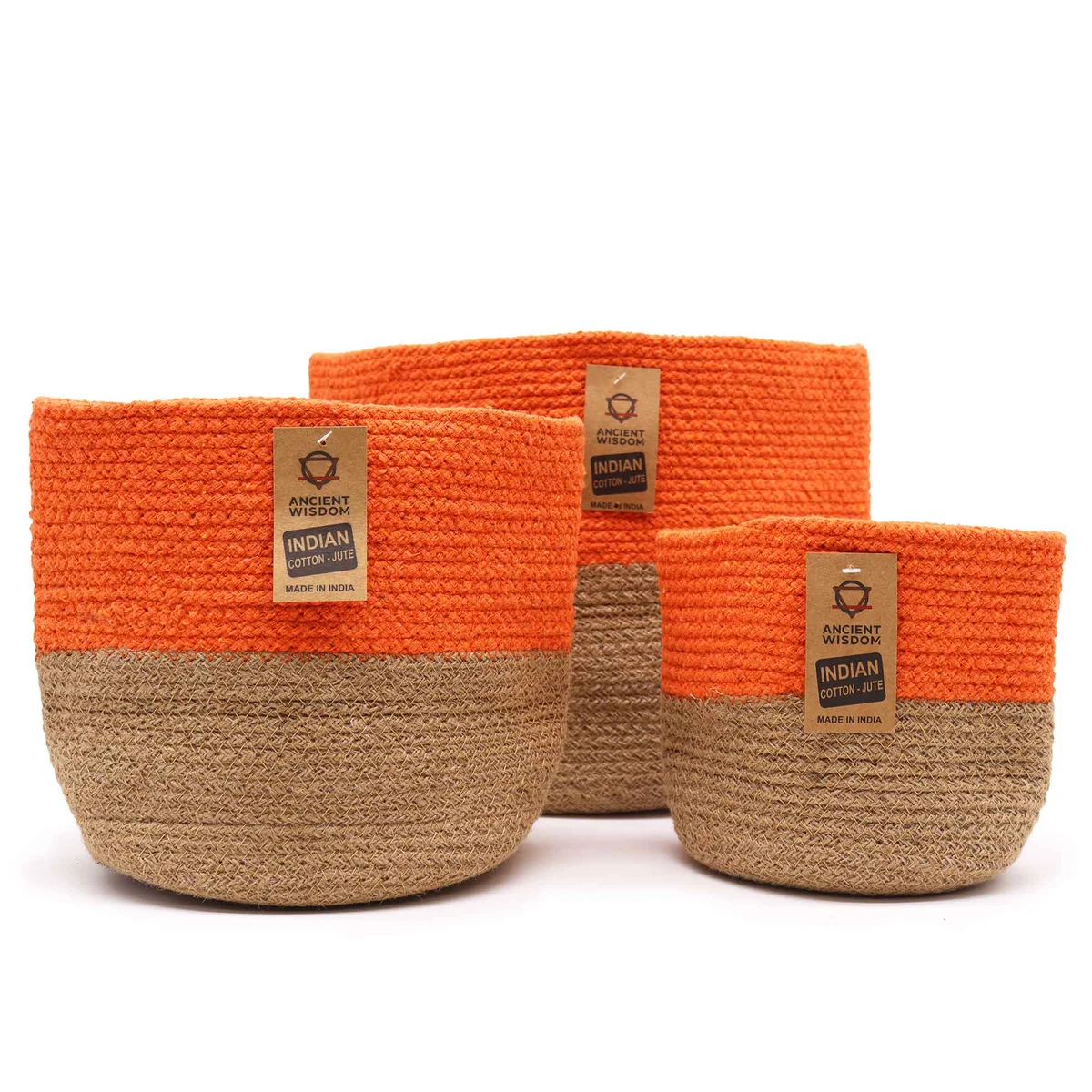 Three orange storage baskets made of cotton rope stacked inside each other on a white background