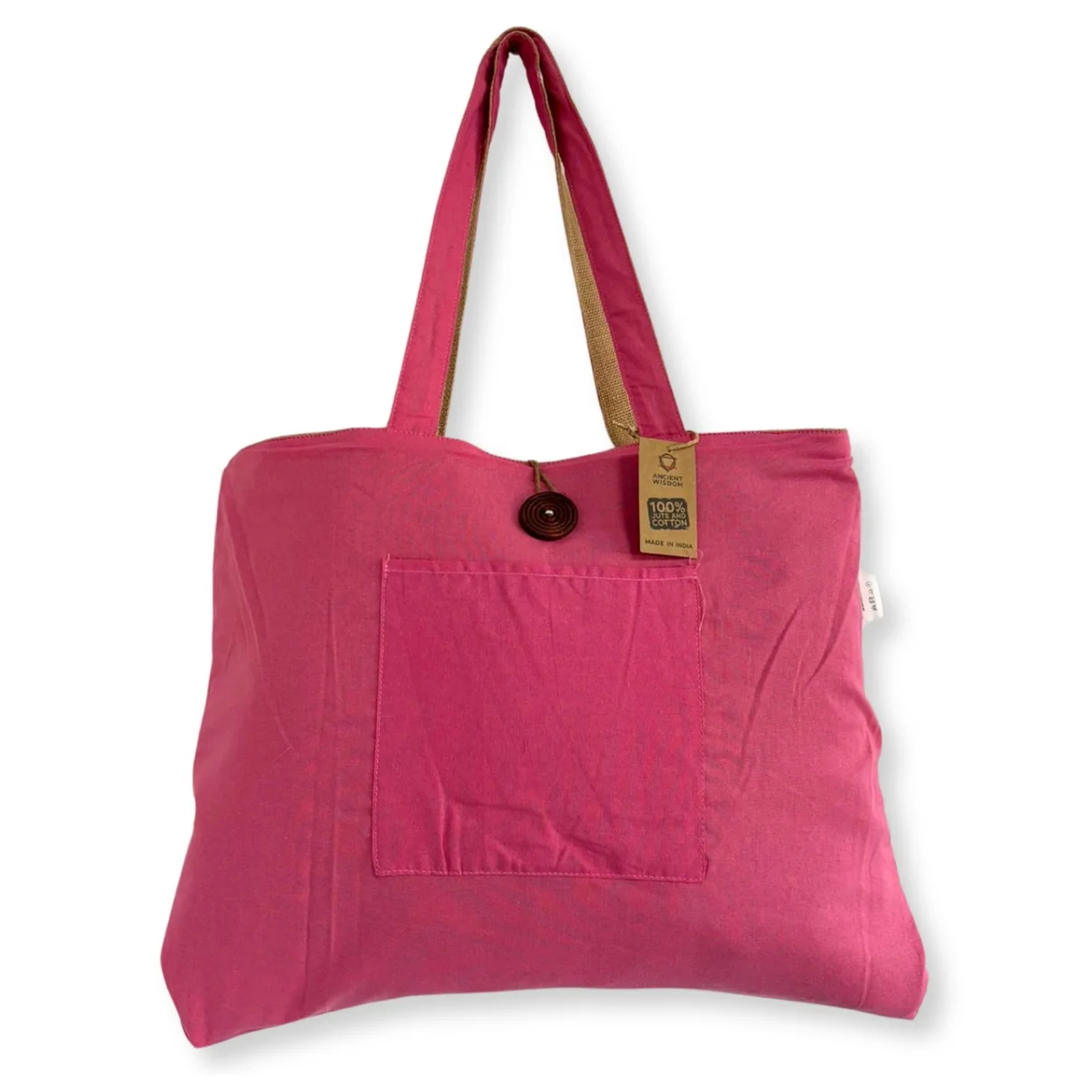 Pink reversible jute bag made from jute and cotton with sturdy handles, shown flat against a white background