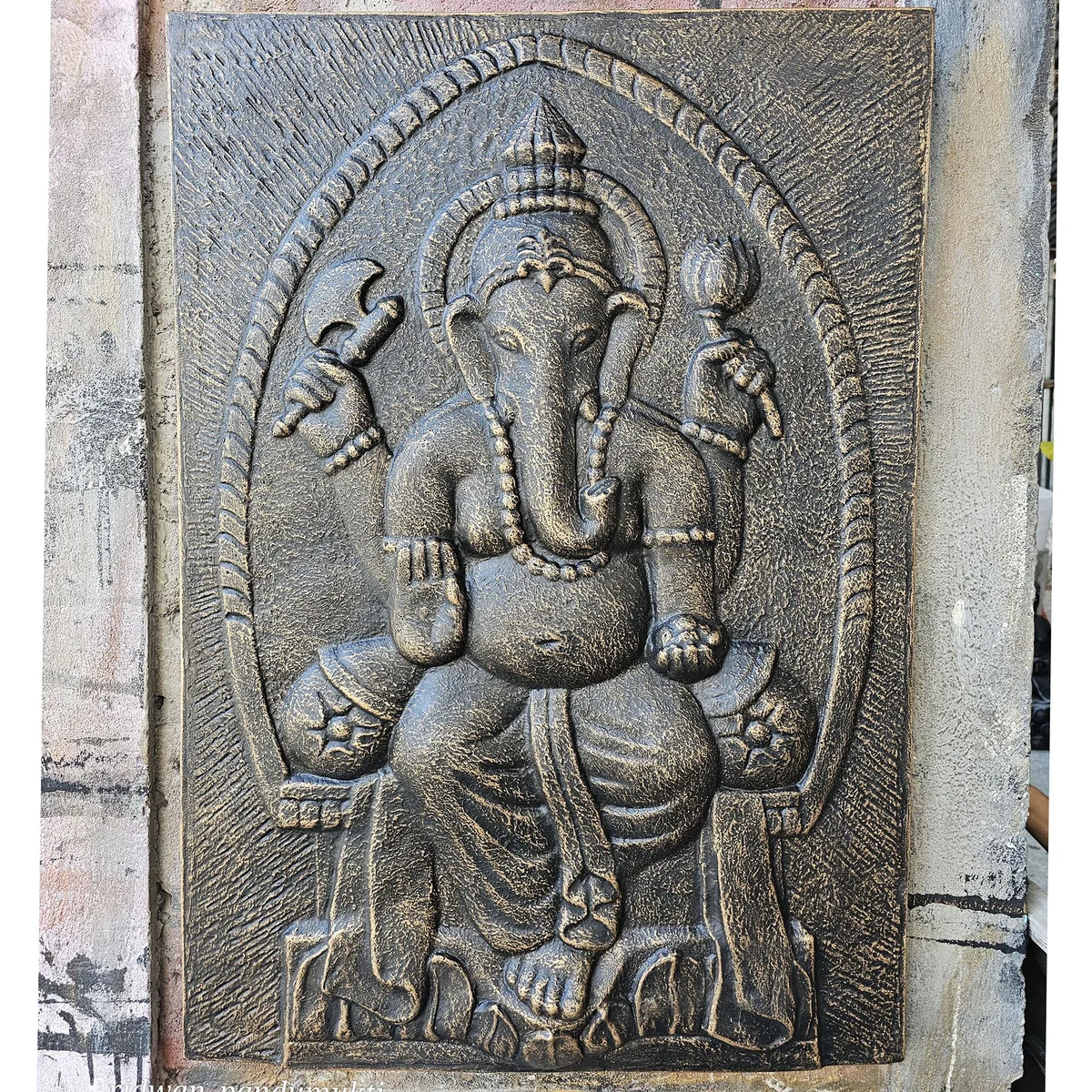 Large Ganpati wall art in antique gold relief on a 0.7x1m iron frame, detailed and decorative design.