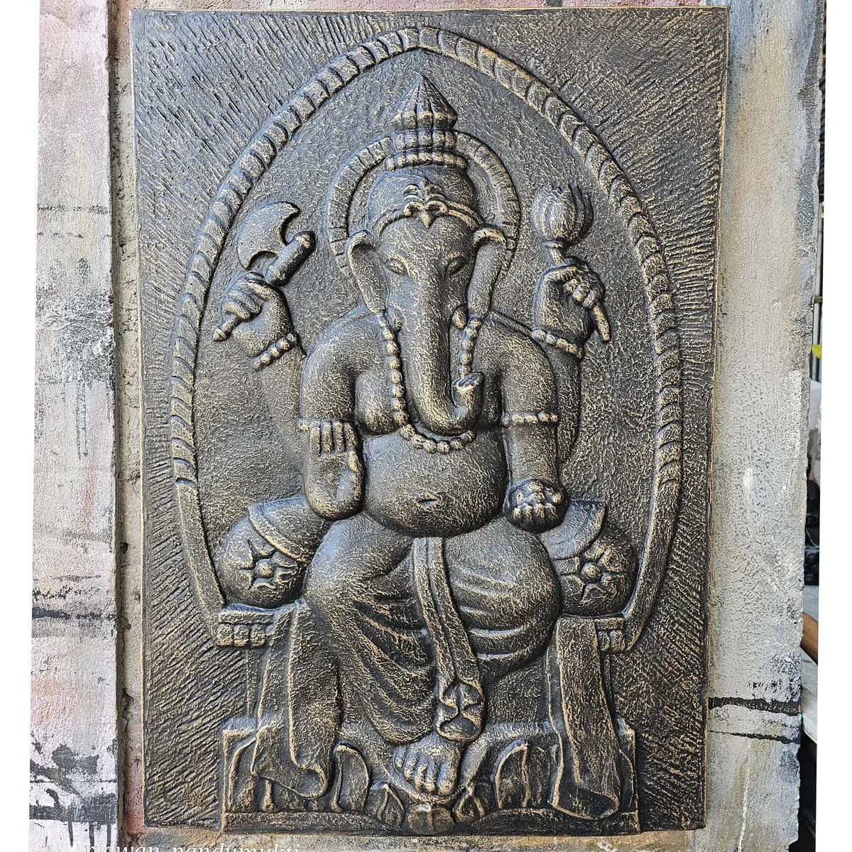 Large Ganpati wall hanging in antique gold relief on iron frame, measuring 0.7 by 1 meter