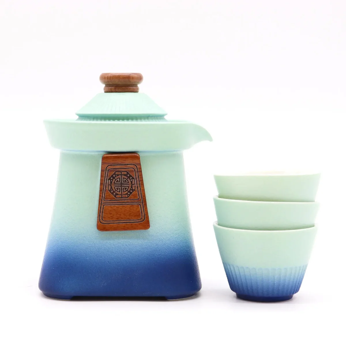 Blue teapot set with a temple design and three matching cups on a white background