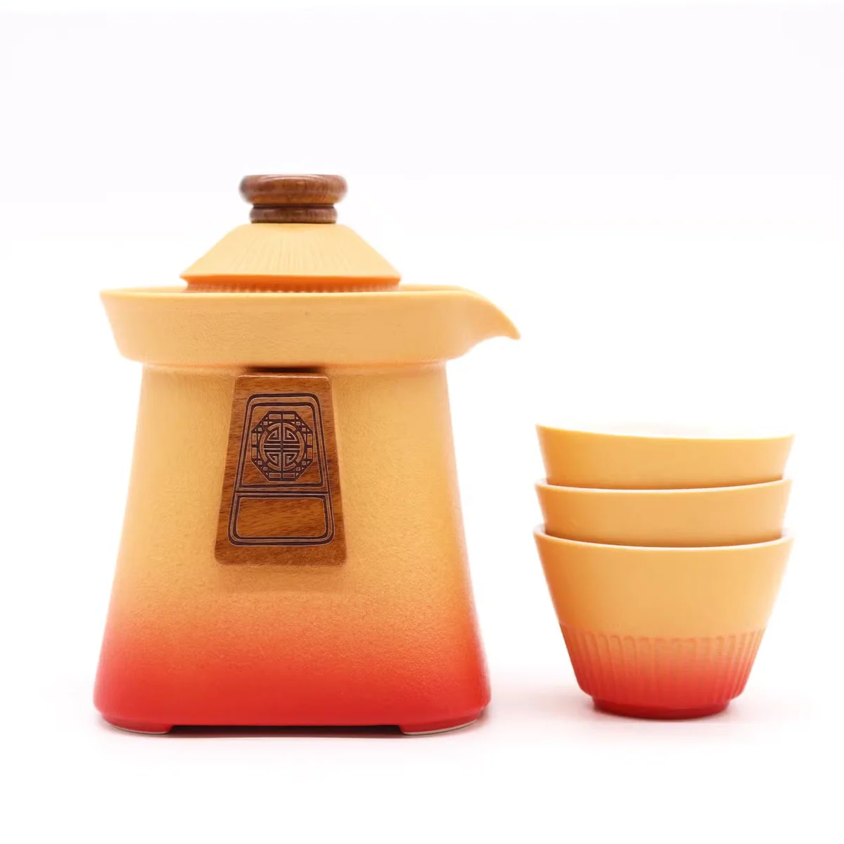 Orange Earth ceramic teapot set with three matching cups arranged on a wooden surface
