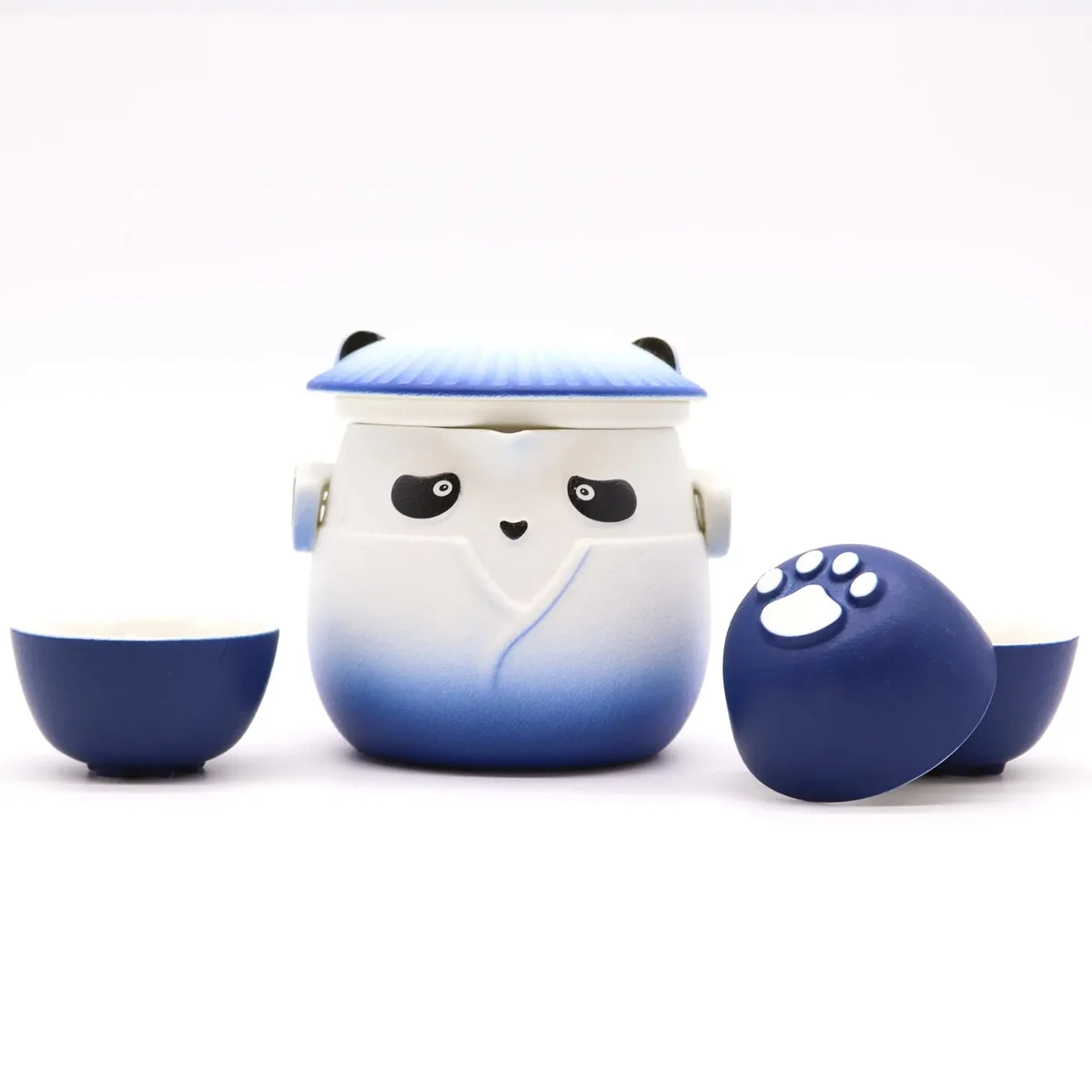 Sky blue teapot set with panda design and three matching cups on a white background