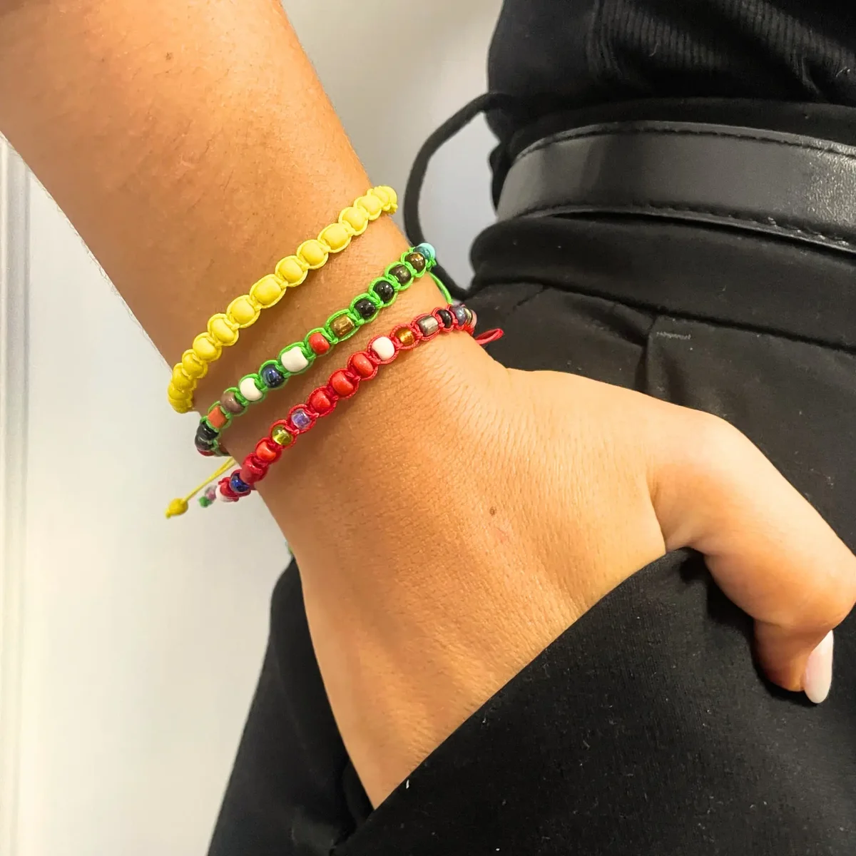 Colorful handmade friendship bracelets uk with tiny forever beads arranged on a white background