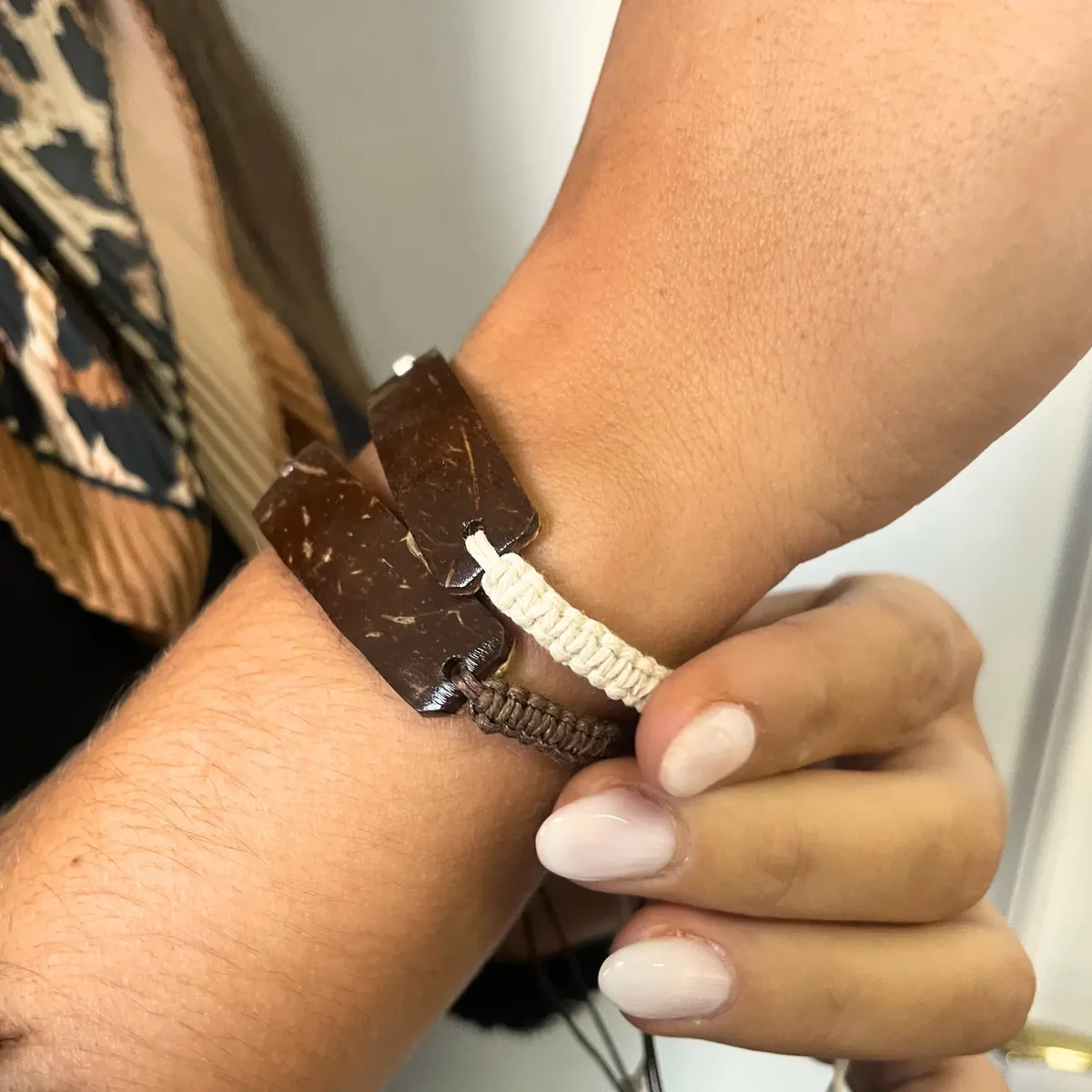 Handmade unprinted custom friendship bracelets made with coconut, assorted styles and colors on white background