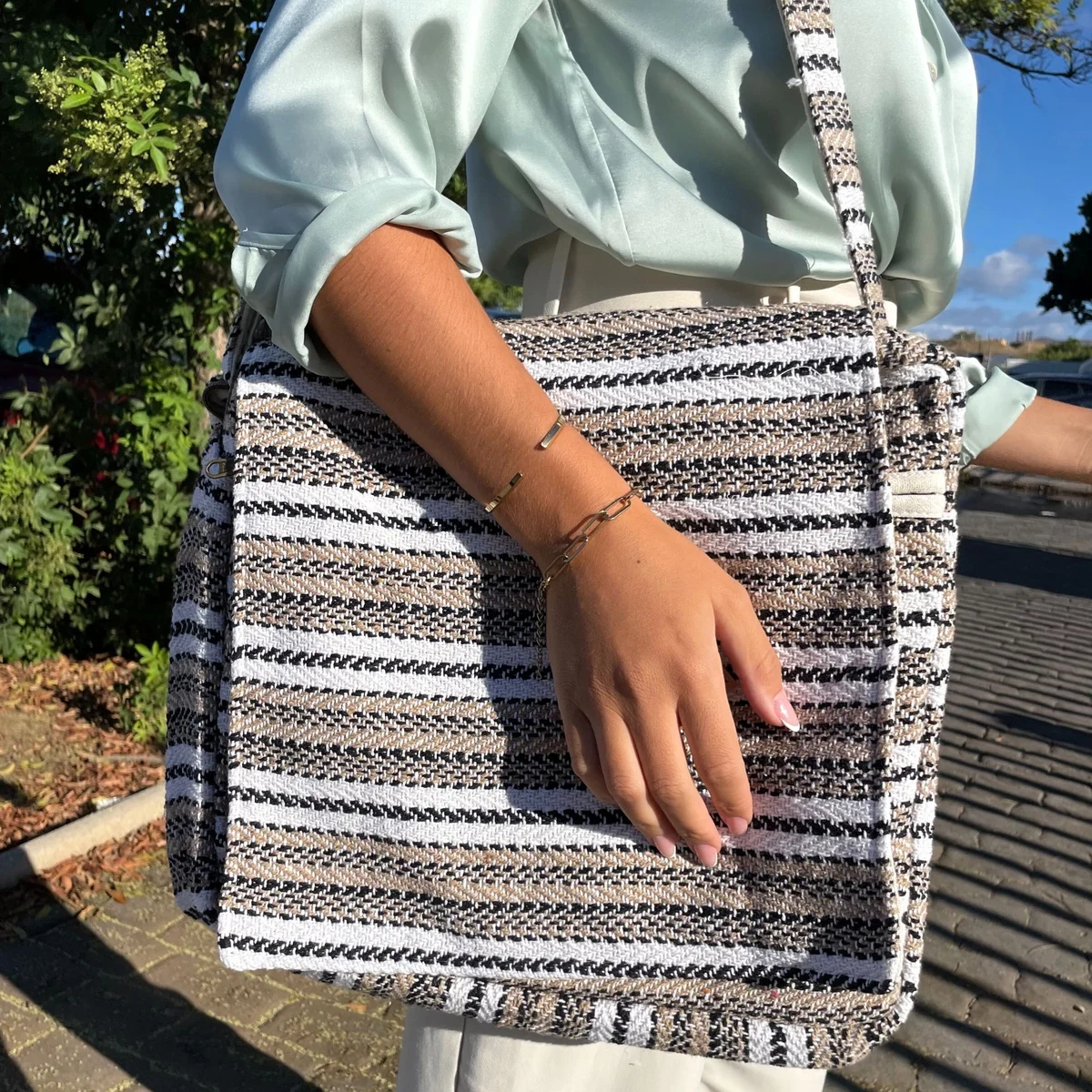 Soft cream and grey soft laptop bag with handles and zip closure, designed for carrying laptops and accessories