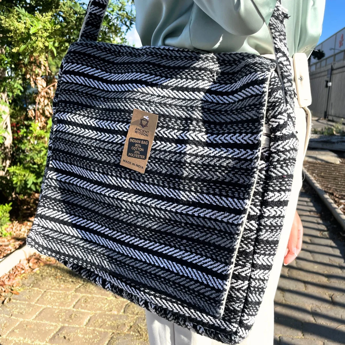 Grey soft laptop bag with striped pattern designed for carrying laptops securely and comfortably