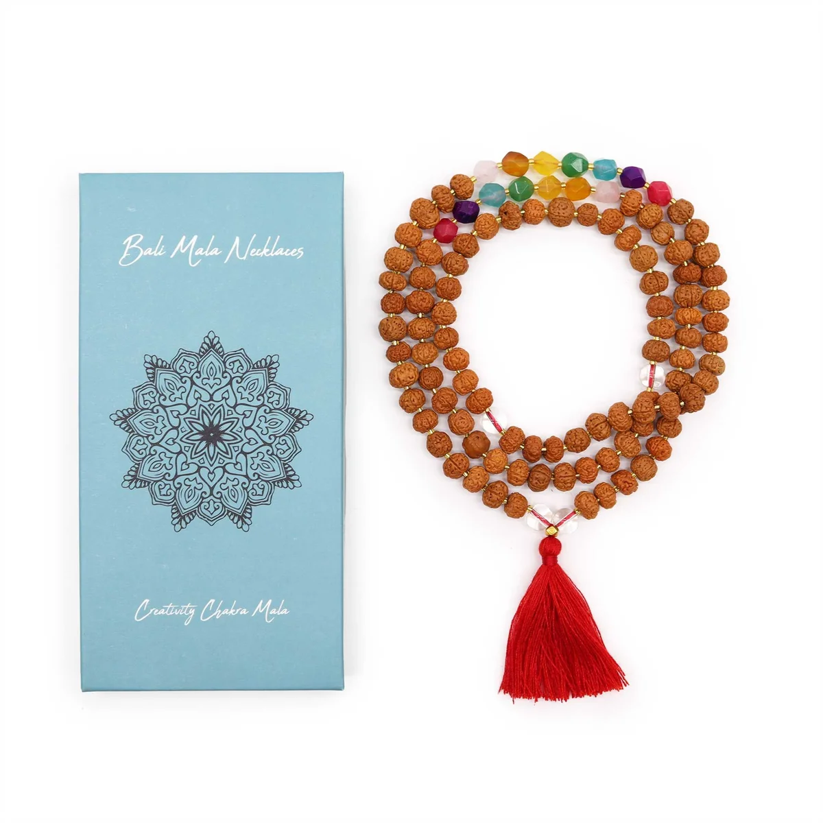 Bali mala necklace featuring creativity chakra beads on a string with decorative tassel on a white background
