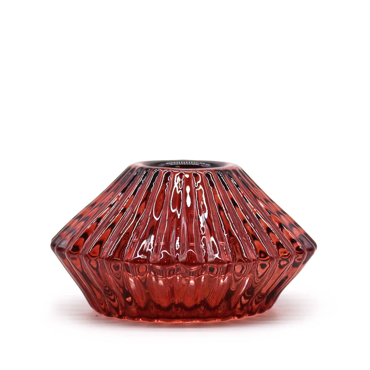 Decorative tealight holder red with flower flip design, holding a single candle, set on a table surface