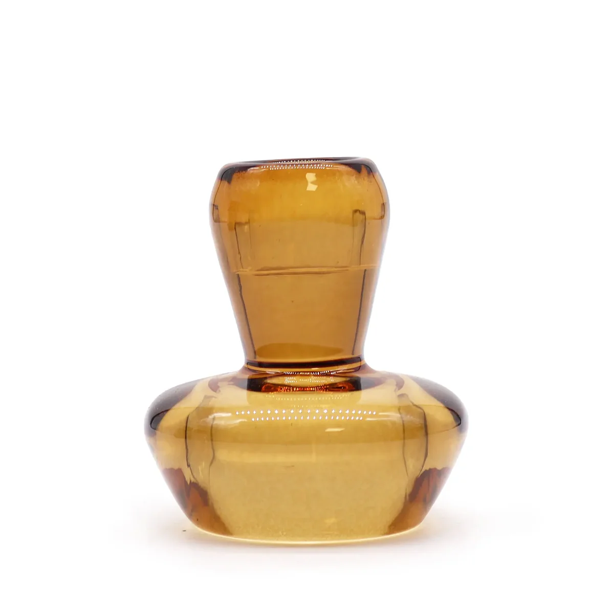 Mushroom shaped antique amber dinner candle holder with open lid, showing tealight flame, resting on tabletop.