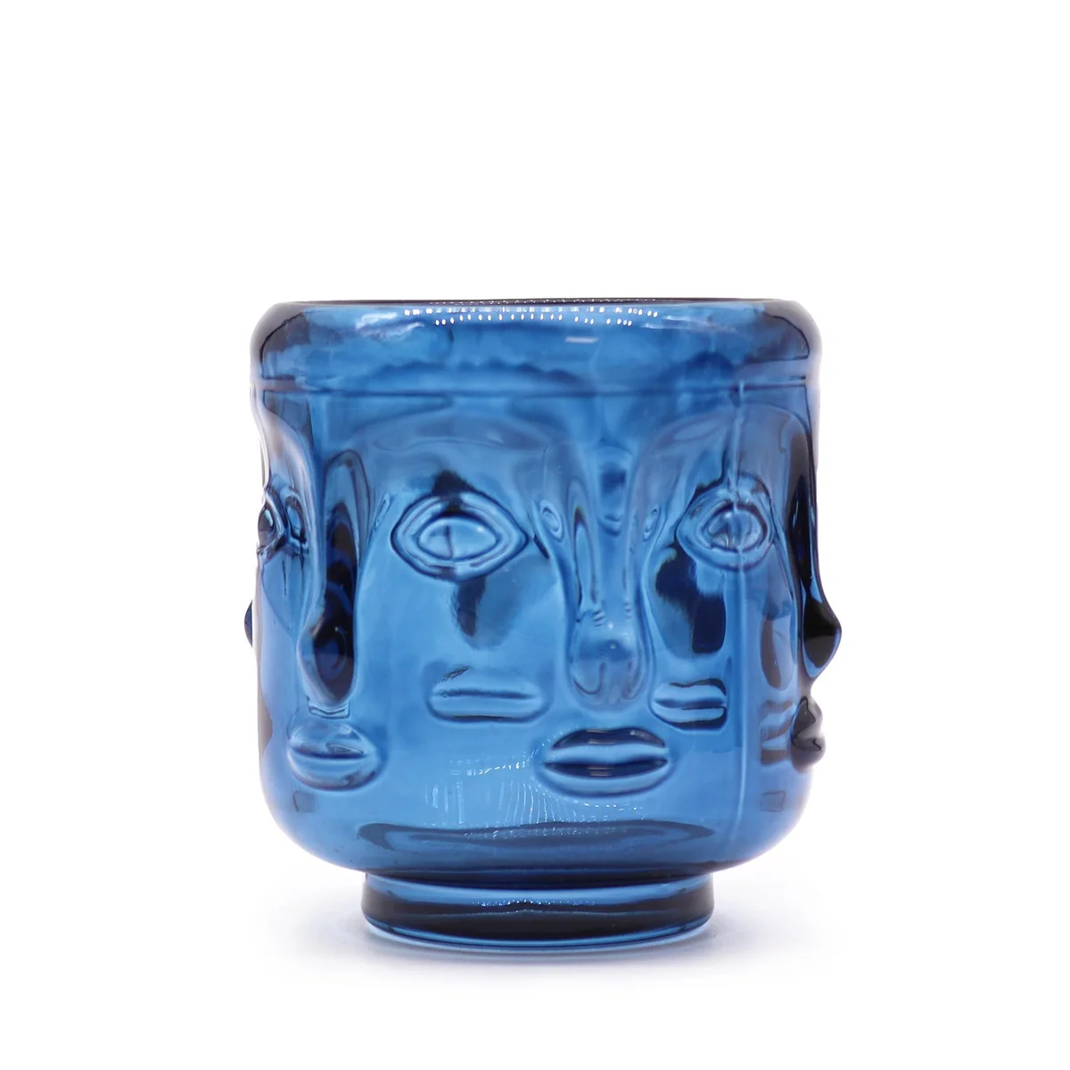 Royal blue Buddha candle jar with serene Buddha faces etched on rim.