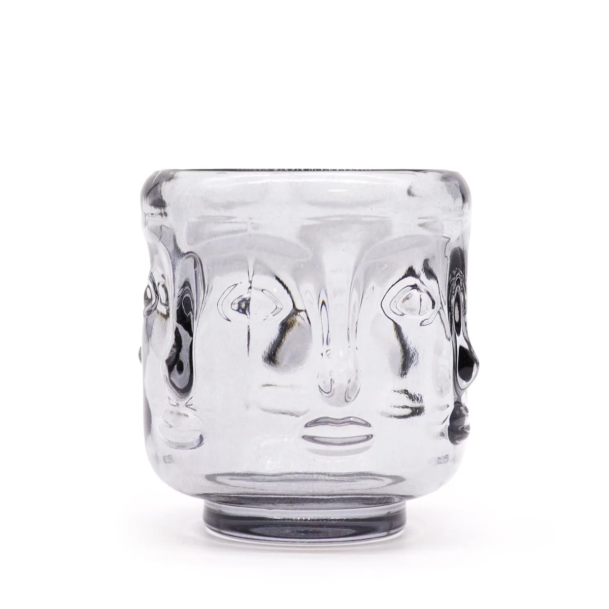 Buddha candle jar in midnight grey, featuring carved Buddha faces.