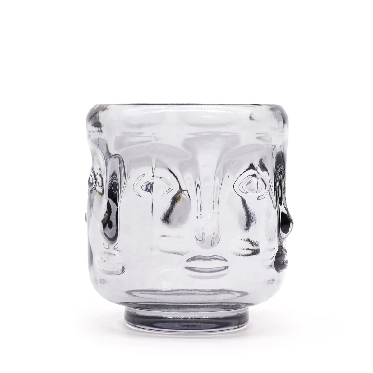 Decorative candle jar featuring Buddha faces, matte midnight grey ceramic.