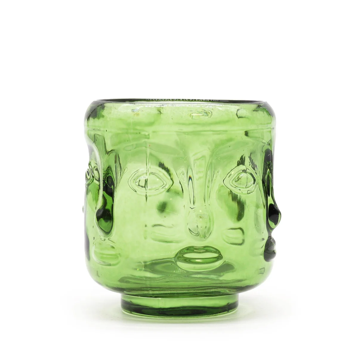 Buddha candle jar with Buddha faces, styled in garden jade.