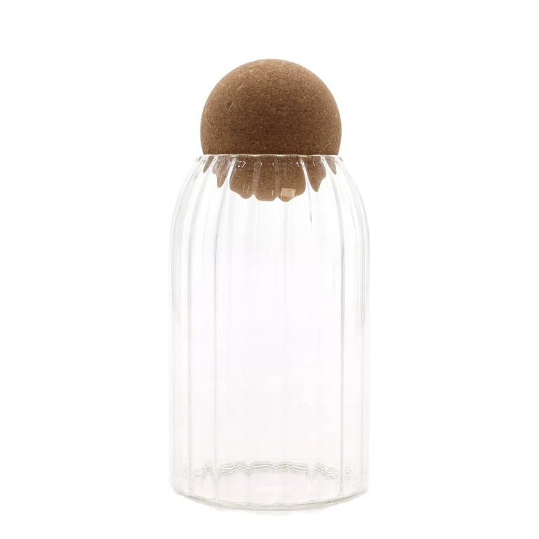 Ribbed glass jar with cork ball lid, 15cm tall, showcased on a wooden table with soft natural lighting.