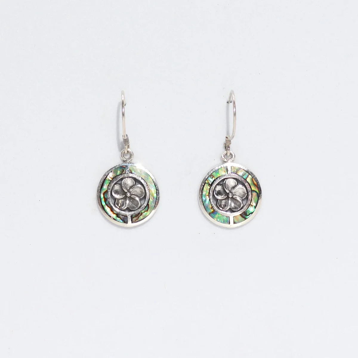 Abalone shell earrings featuring silver accents, frangipani motif.
