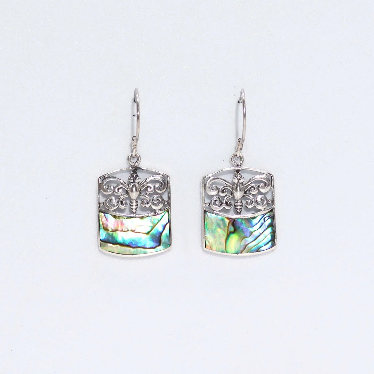 Abalone shell jewellery earrings with a silver dragonfly design.
