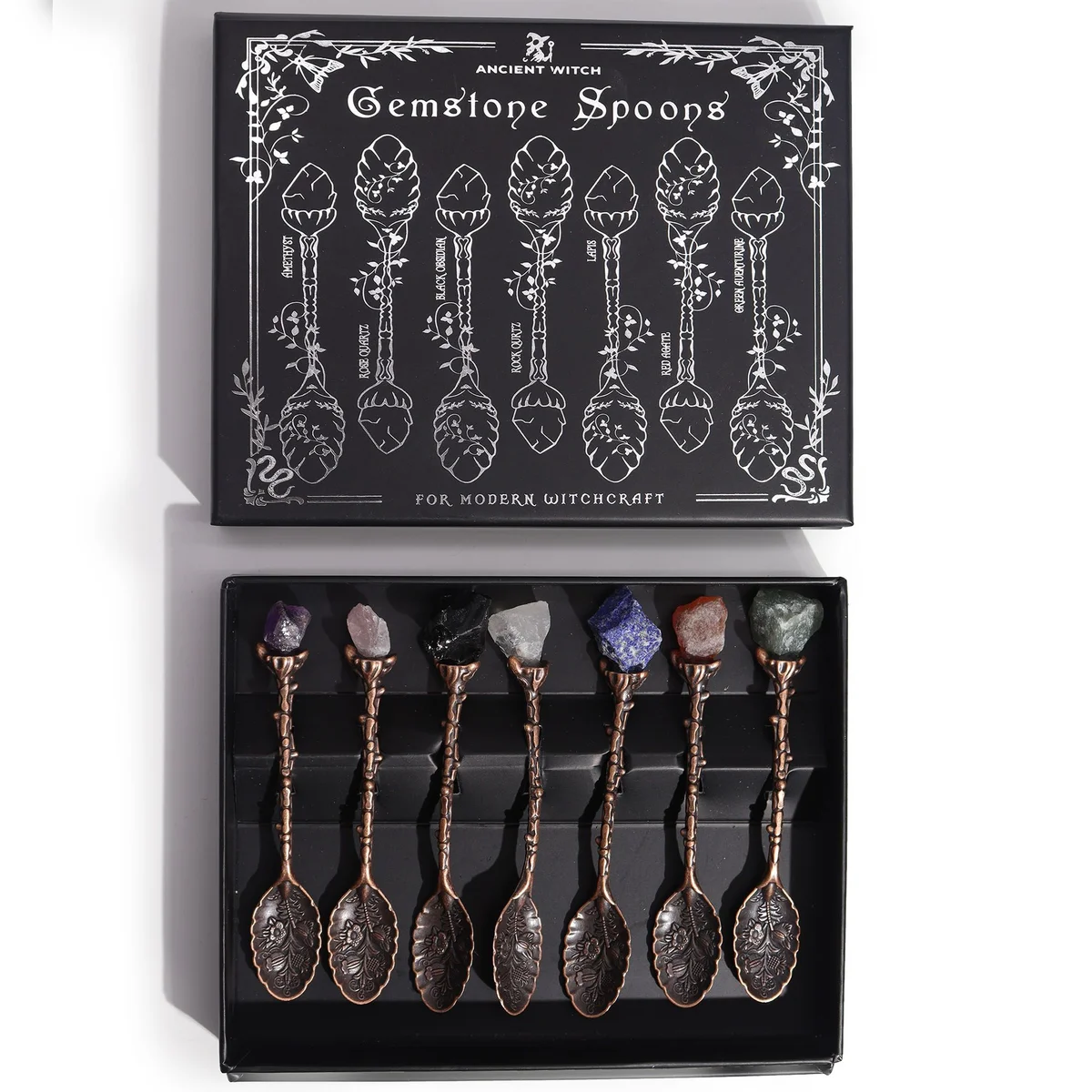 Set of seven bronze gemstone crystal witch spoons displayed together.