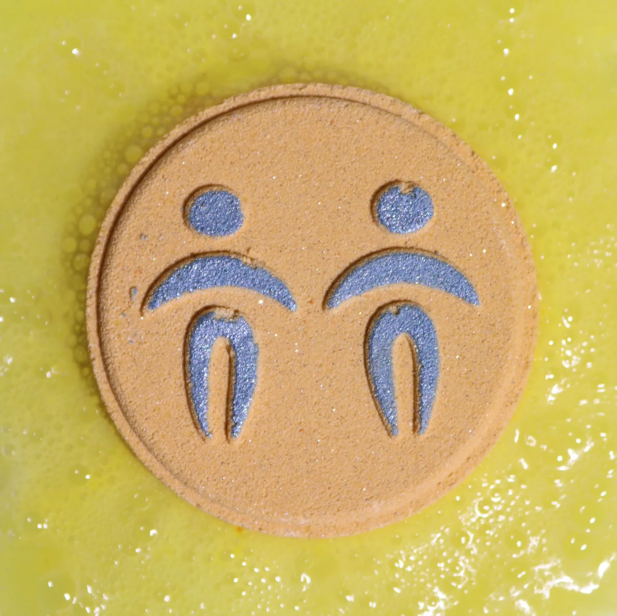 Set of Gemini Zodiac bath fizzers arranged with horoscope symbols on a white background