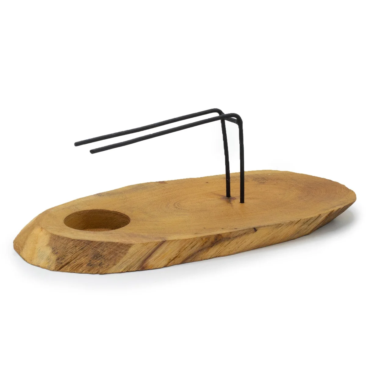Palo Santo heater made of natural gamel wood resting on a wooden surface