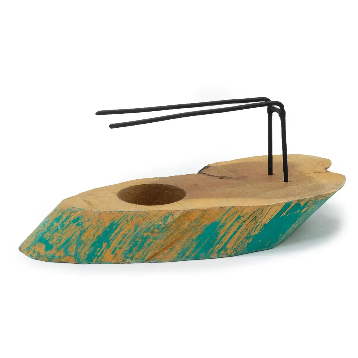 Palo Santo Heater in Greenwash Gamel wood set on a wooden surface.