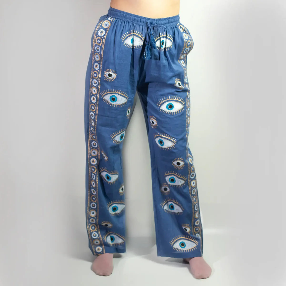 Rich blue Nomad Sari Lounge Pants featuring a hand-painted evil eye design in gold