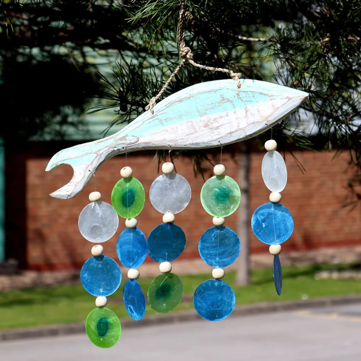 Carved fish sculpture and Copis drop displayed as aquatic themed decor