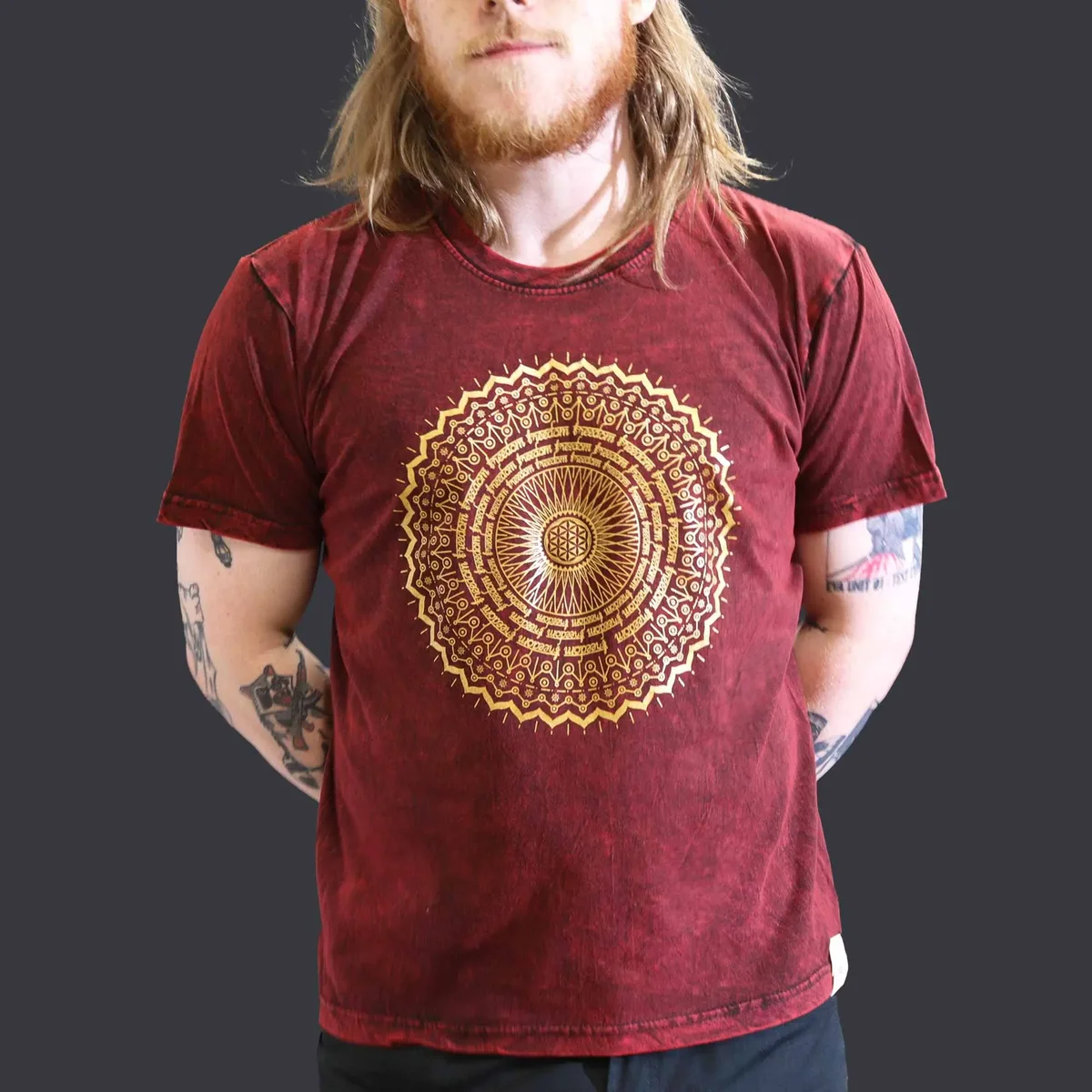Maroon large t-shirt with stone washed texture and mandala design on front displayed on plain background