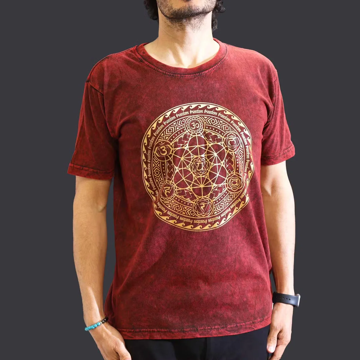 Maroon stone washed tee with chakra design, medium size, laid flat against white background