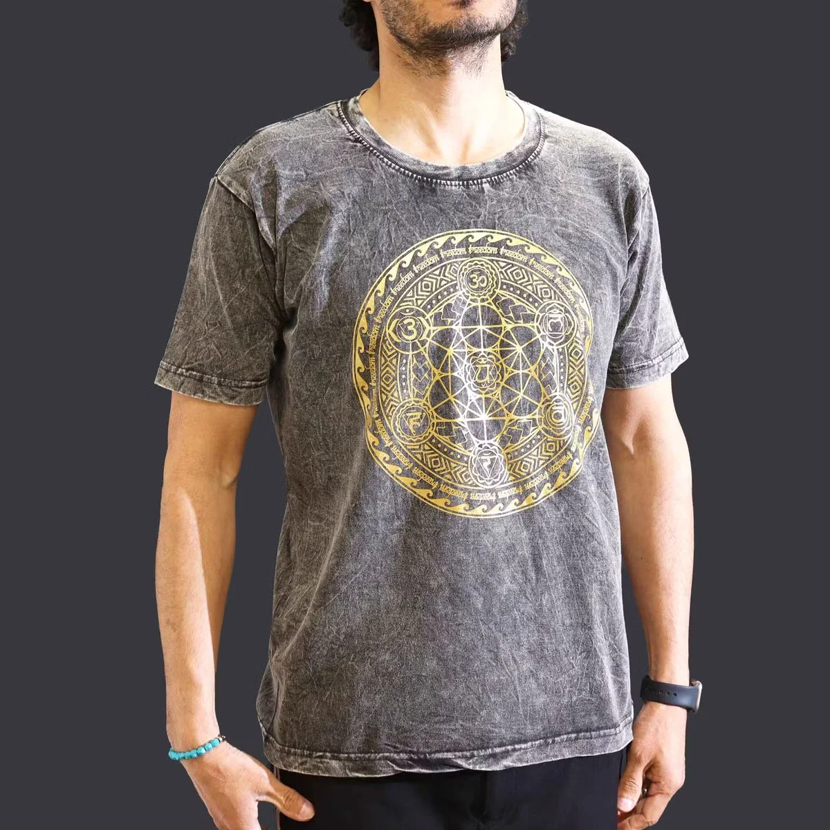 Dark grey medium stone washed tee with chakra design, displayed flat against a white background, showing front view